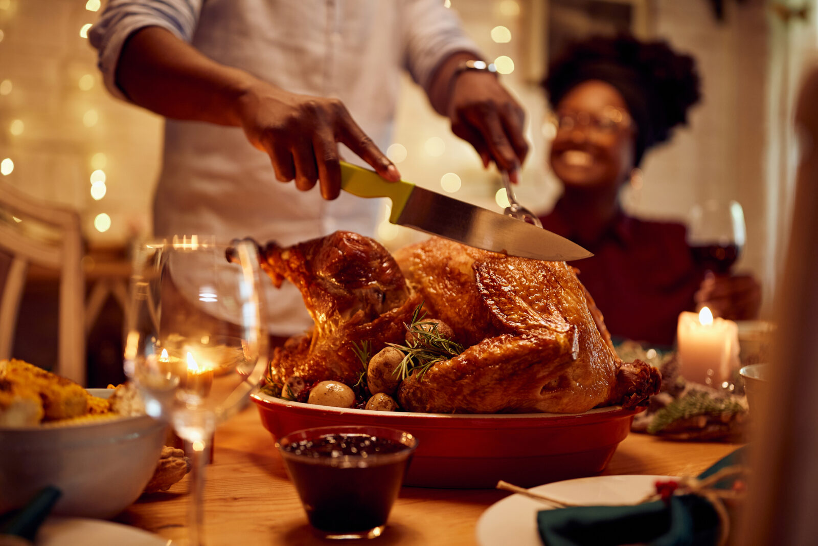 A close up of a turkey being carved on a table set for Thanksgiving dinner, to illustrate an LCA blog post on keeping FOGs (fats, oils, grease) out of the drain.
