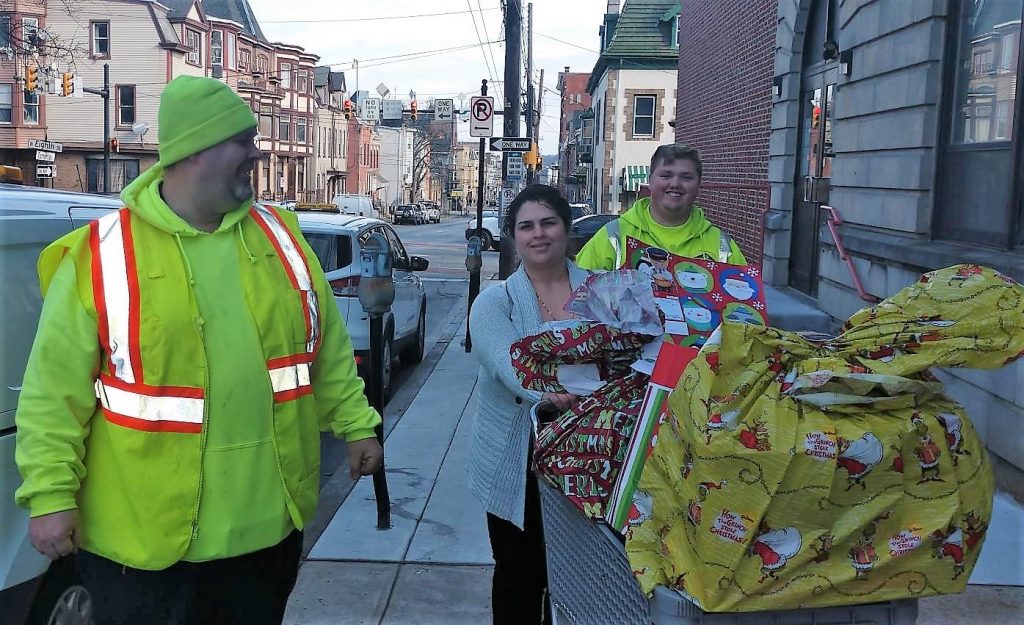 A picture of three LCA employees delivering gifts for children through he Lehigh Valley branch of the Salvation Army.
